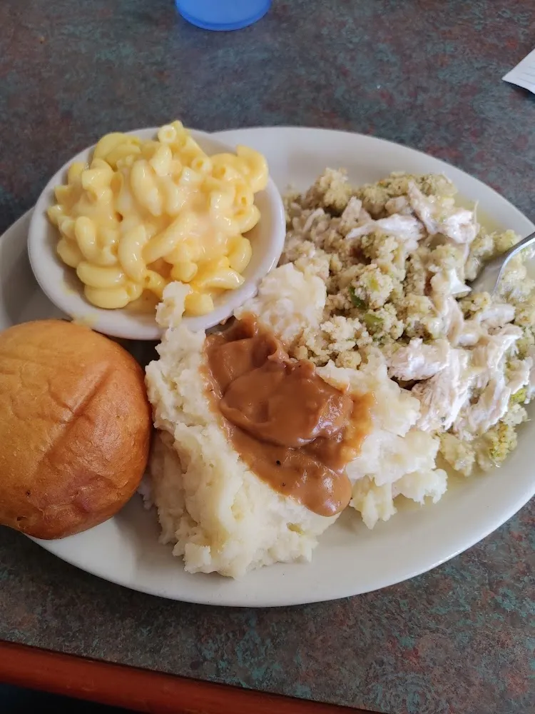 Chicken and Dressing with Mashed Potatoes and Gravy Macaroni and Cheese and a Dinner Roll